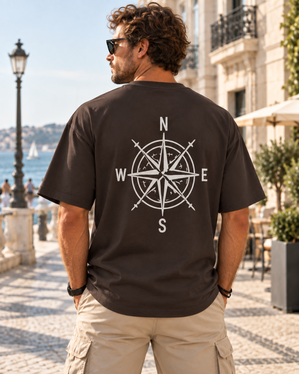 Vista trasera de la camiseta oversize de IMPARABL3 en color ébano 231, con diseño blanco de rosa de los vientos en la espalda